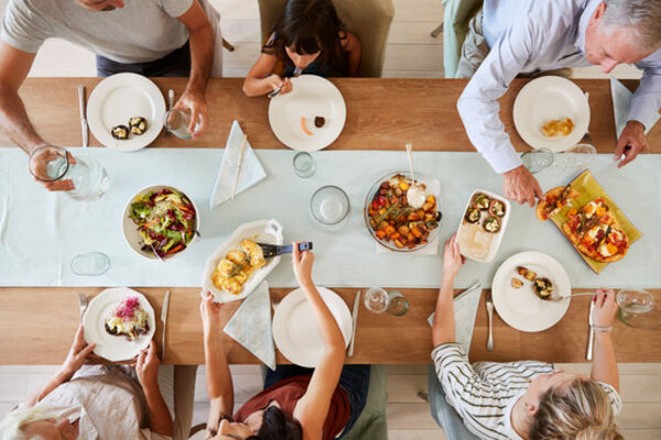 People sharing a simple meal around a table in a relaxed setting